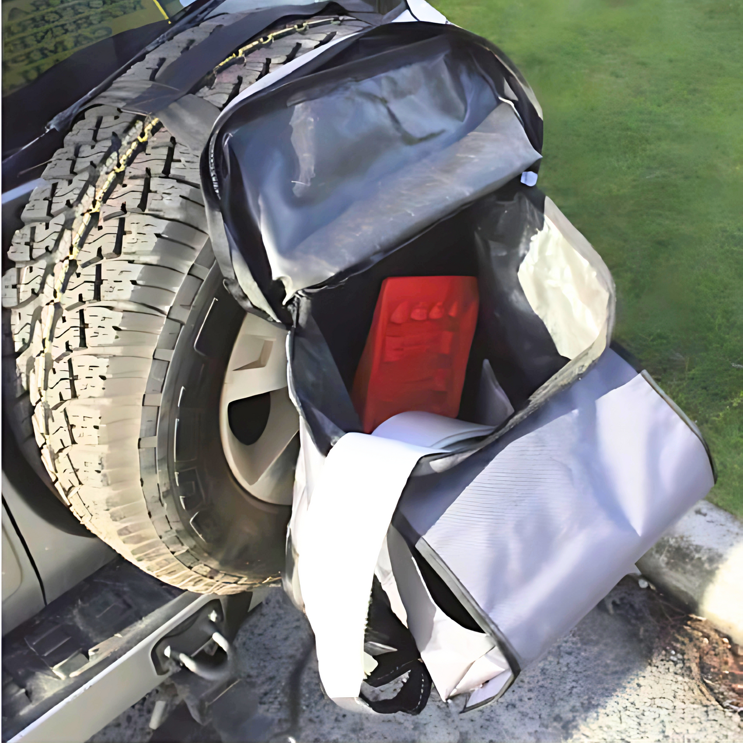 Dirty Devil Spare Wheel Rubbish Bag 64L attached to vehicle for outdoor storage and rubbish collection