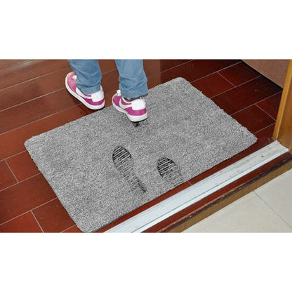 Super absorbent doormat at a doorway with footprints, showing how it soaks up water and dirt to keep floors clean.