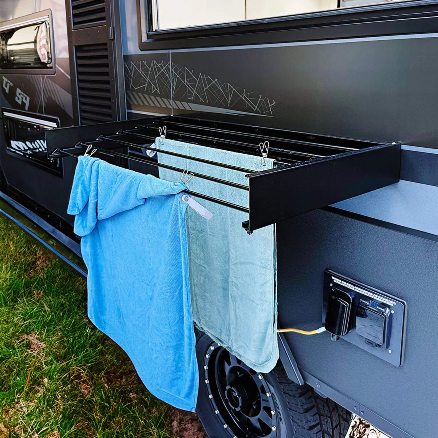 RV wall mounted clothes airer in black used outdoors at campsite