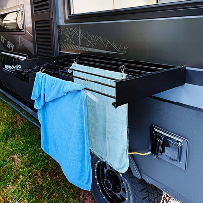 RV wall mounted clothes airer in black used outdoors at campsite