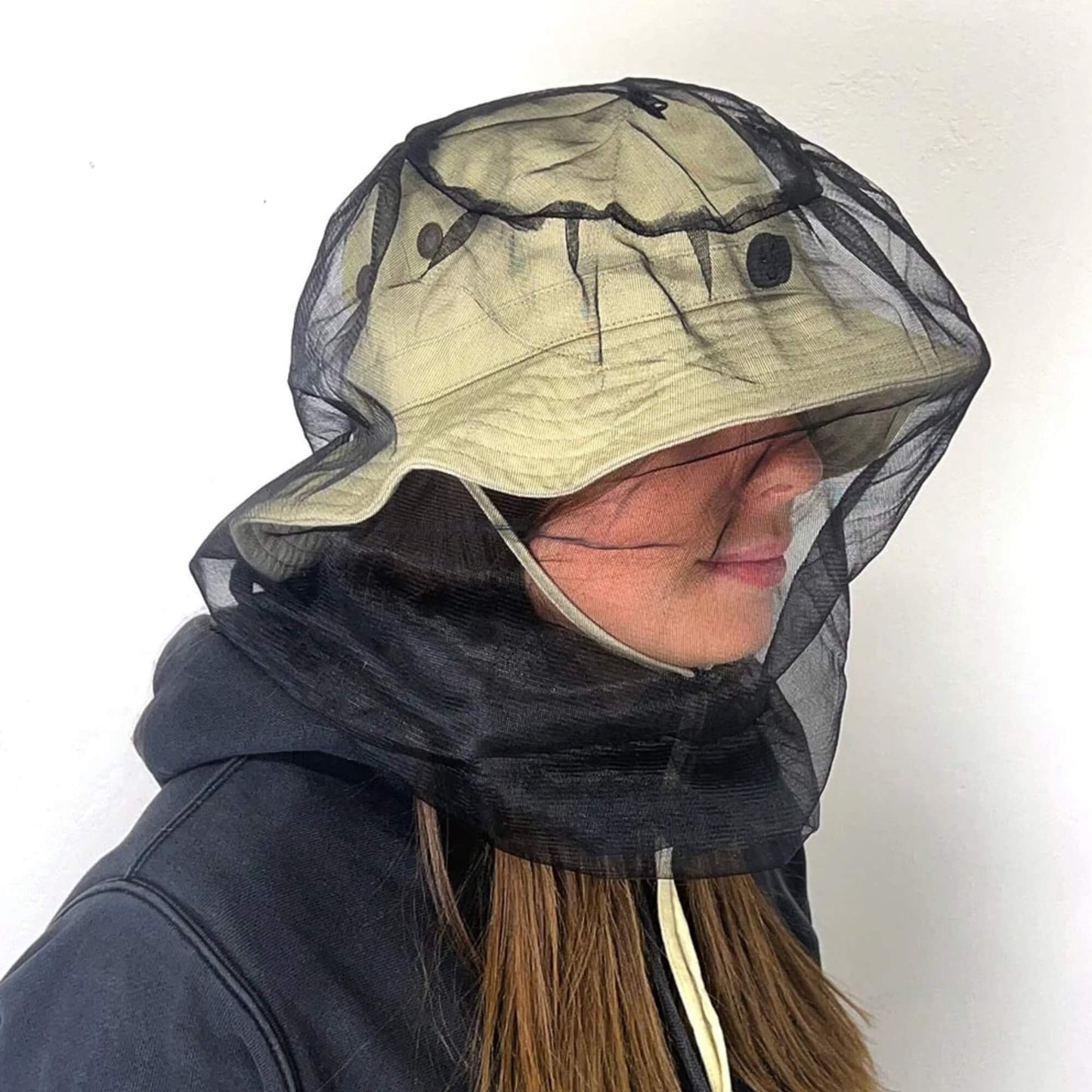 Woman wearing beige mozzie hat with full mesh face and neck protection