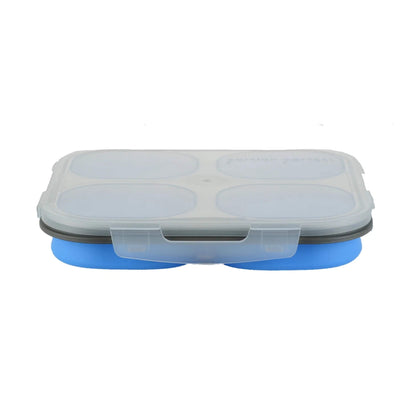 A silicone travel food storage container with a translucent lid, four oval compartments, and a blue base, shown on a plain white background.