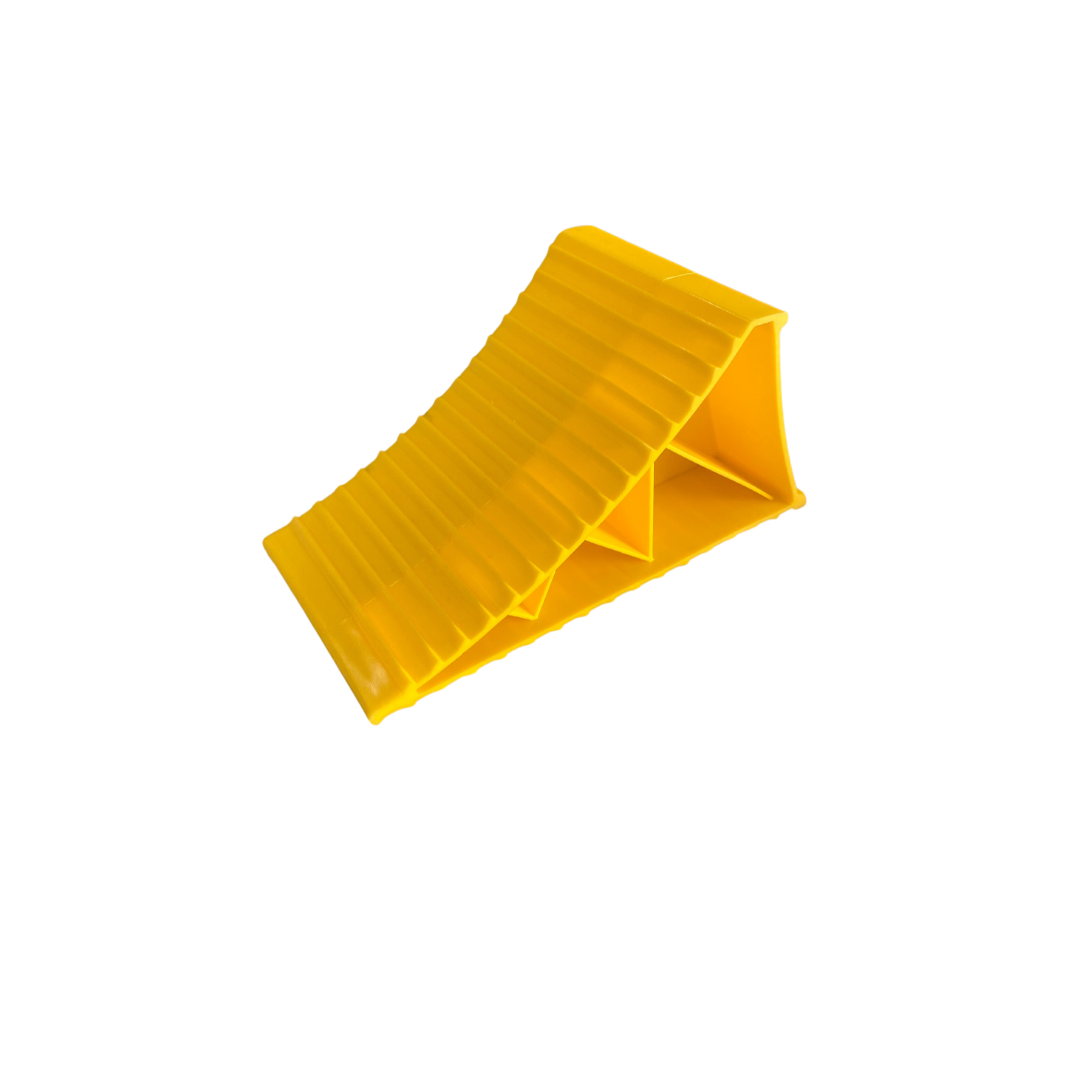 Large yellow wheel chock for caravans, trailers, and motorhomes to prevent movement