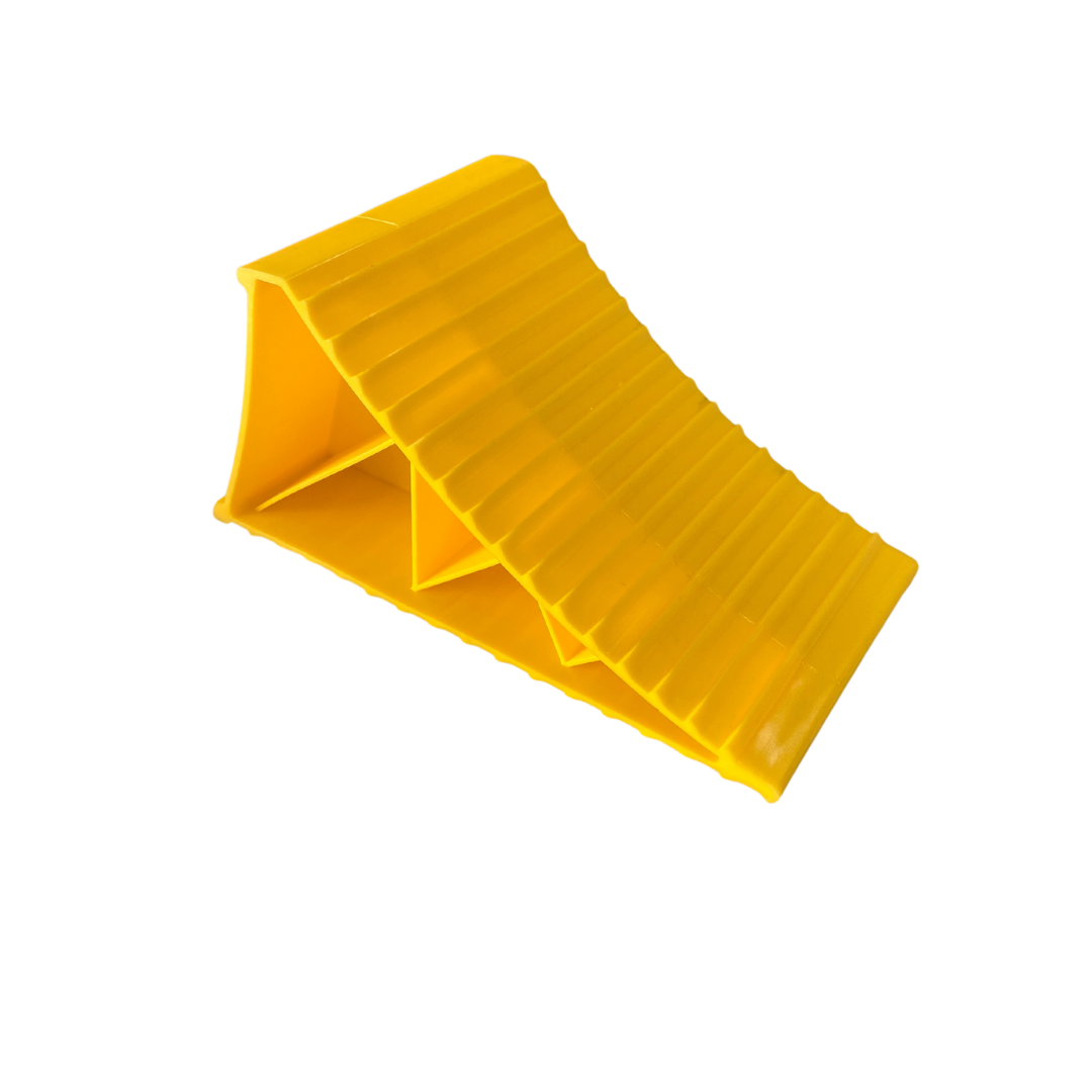 Large yellow wheel chock for caravans, trailers, and motorhomes to prevent movement