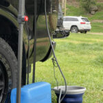 Portable camp shower with USB recharge, clip and suction pads for outdoor use